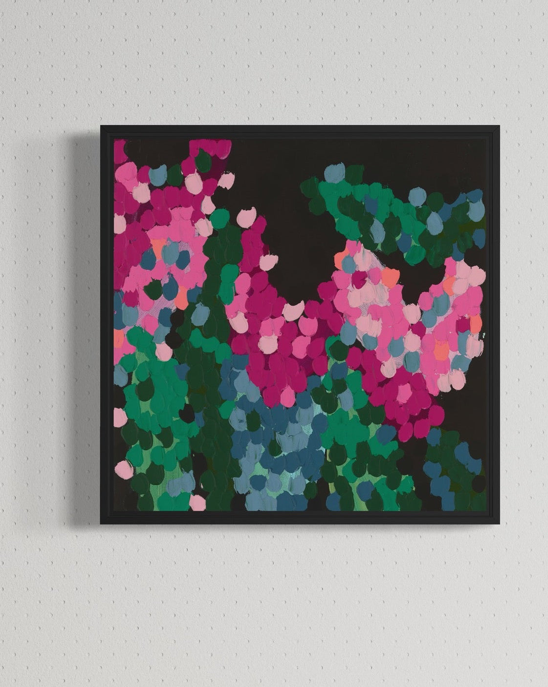 Colorful abstract painting on a wall above a wooden cabinet with a decorative object.